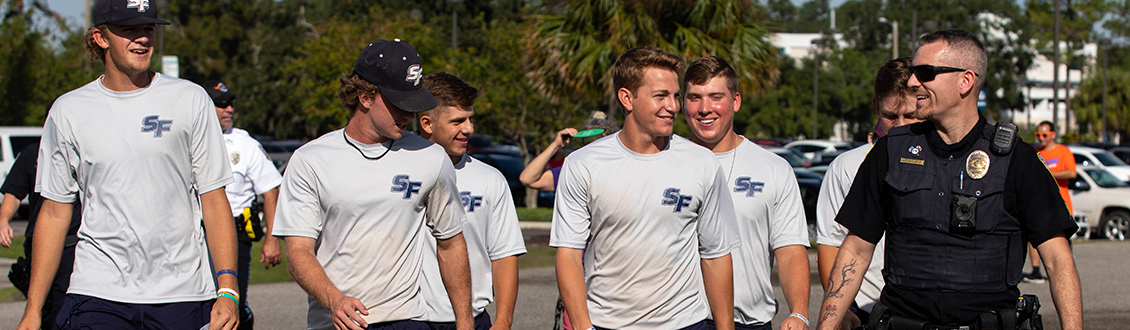 Sgt. Mark Barley with the Santa Fe College Police Department walks with members of the SF Baseball team during the fourth annual Run with the Cops event at Santa Fe College on Tuesday, Nov. 8, 2018 in