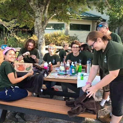 group of zookeepers making enrichment from recycled items
