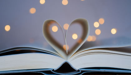 Book open with pages shaped into a heart