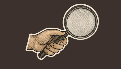 Hand holding a magnifying glass