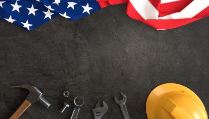 The American flag at the top of the image with tools and a hard at the bottom of the image