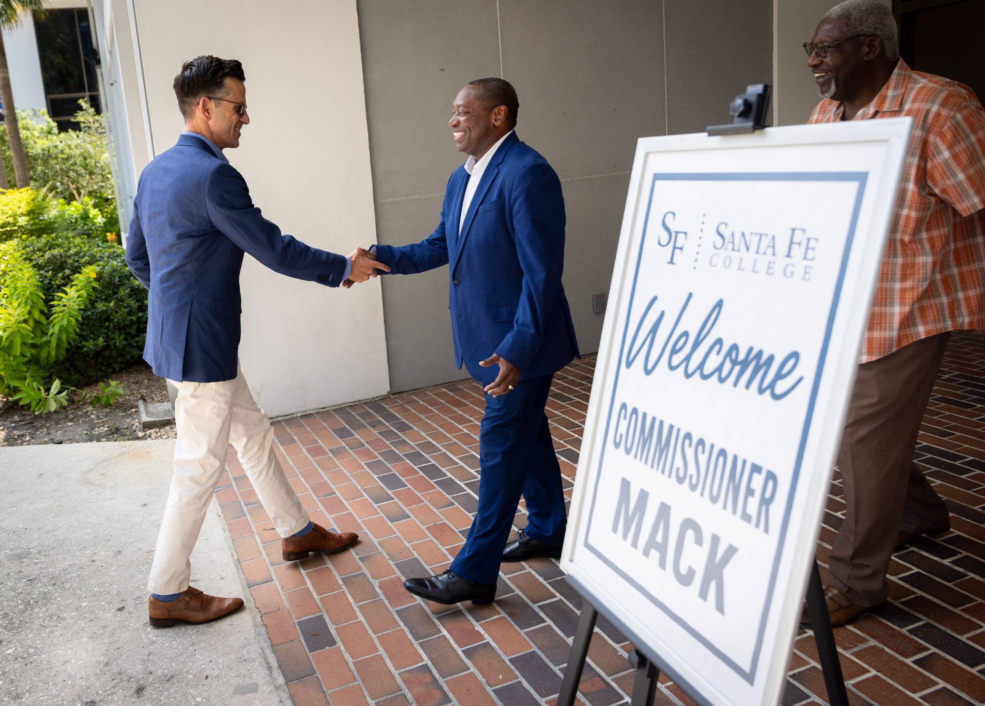 Dr. Henry Mack shakes hands with Dr. Paul Broadie