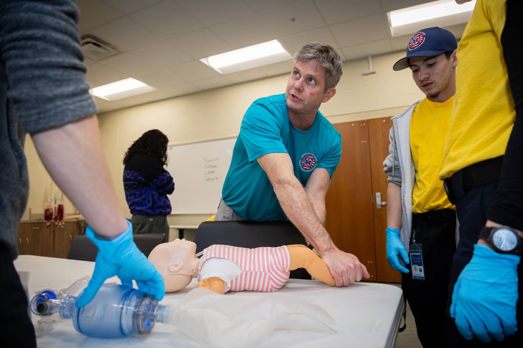 Instructor coaches students on medical technique